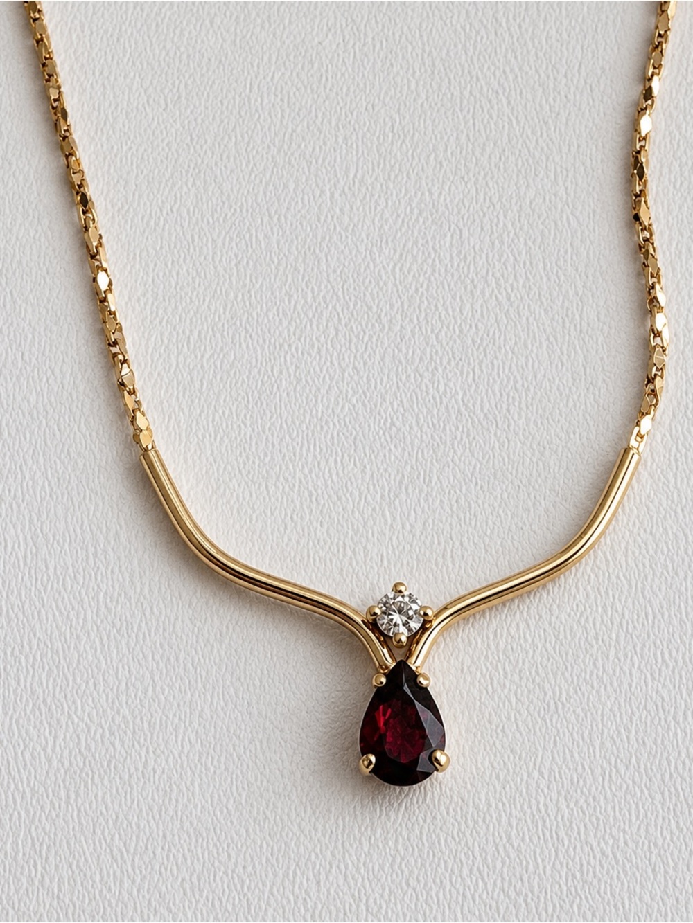 Gold tone necklace with garnet & diamond 16"